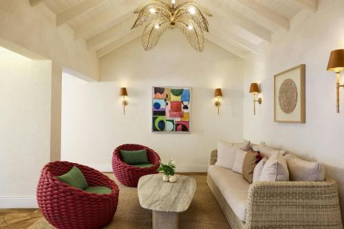 a living room with a couch and chairs and a chandelier at Treasure Beach Art Hotel, An Autograph Collection All-Inclusive Resort in Saint James