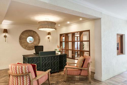 a living room with two chairs and a desk at Treasure Beach Art Hotel, An Autograph Collection All-Inclusive Resort in Saint James