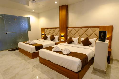 a hotel room with two beds in a room at Hotel Sterling Executive in Navi Mumbai