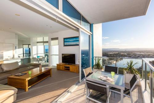 a living room with a couch and a table at Artique Surfers Paradise - Official in Gold Coast