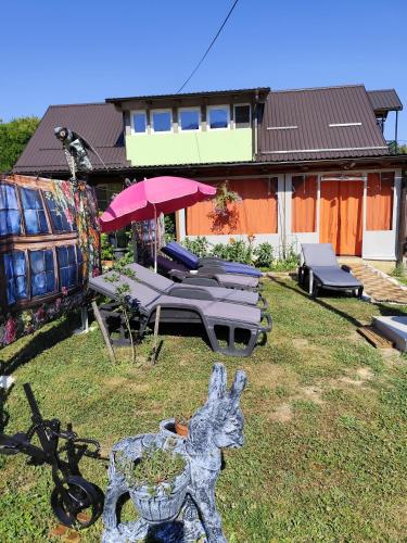 a garden with a table and chairs and an umbrella at Zeleni raj in Hreljin Ogulinski