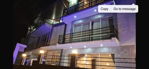 a building with purple lights on it at night at Premier Villa in Nuwara Eliya