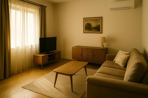 a living room with a couch and a tv at Aleksandar Apartments in Kavadarci