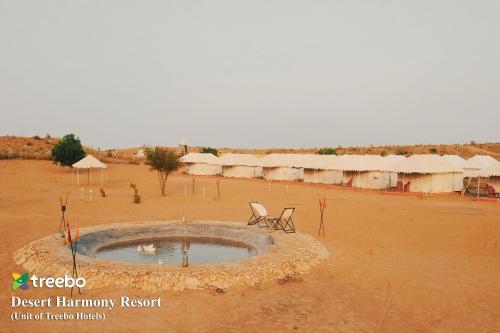 a desert laneway resort with a pool in the middle of a desert field at Treebo Desert Harmony Camp in Sām