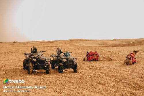 two atvs and a camel in the desert at Treebo Desert Harmony Camp in Sām