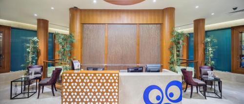 a lobby with a waiting area with chairs and a counter at Hilton Bursa Convention Center & Spa in Bursa