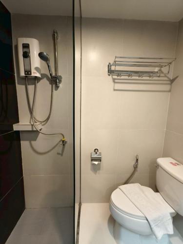 a bathroom with a shower and a toilet at Buritel Hotel in Buriram