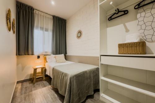 a small room with a bed and a window at Novus Homes Barcelona Santa Eulalia in Hospitalet de Llobregat