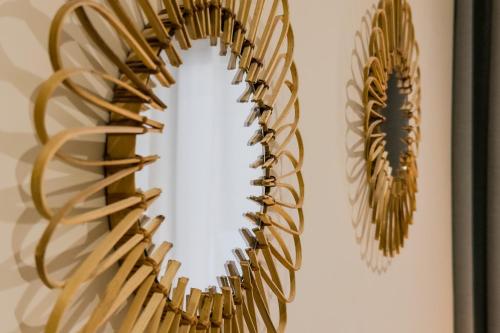 a gold feather wall hanging on a wall at Novus Homes Barcelona Santa Eulalia in Hospitalet de Llobregat