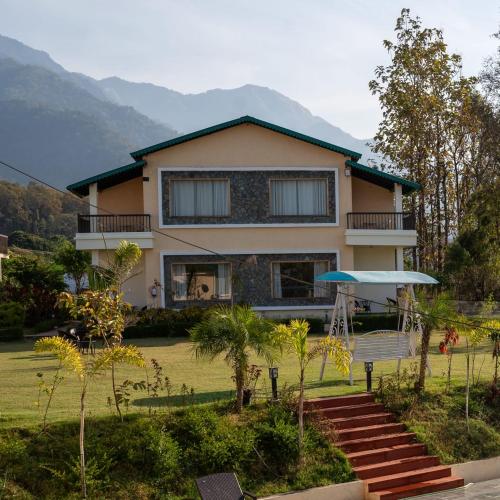 a large house with a yard with a house at Kudrat Resort-Jim Corbett in Kota Bāgh