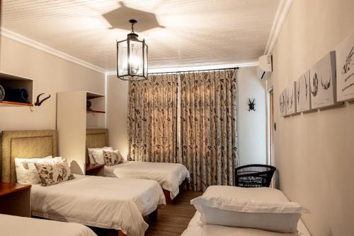 a room with two beds and a chandelier at Kareestomp in Aberdeen