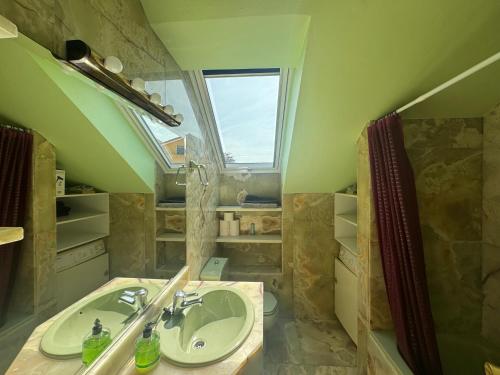 a bathroom with a sink and a window at Apartamento Tere in Llanes