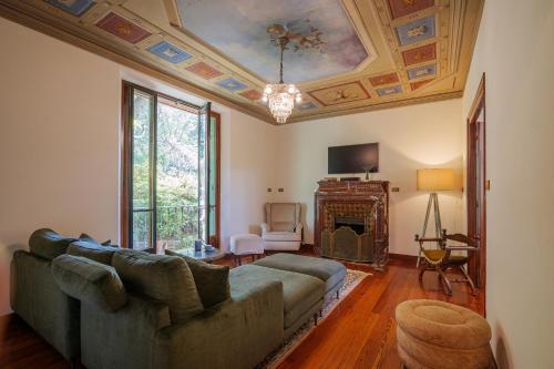a living room with a couch and a fireplace at Villa Spa Dalia in Cannobio