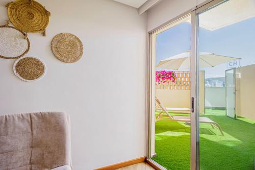 a living room with a sliding glass door to a patio at Cullera Holiday in Cullera