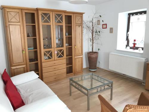 a living room with a couch and a glass table at Ferienwohnung Udenheim in Udenheim