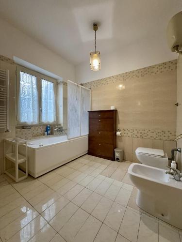 a bathroom with a tub and a toilet and a sink at La casa tra gli ulivi di Fonte Nuova in Fonte Nuova