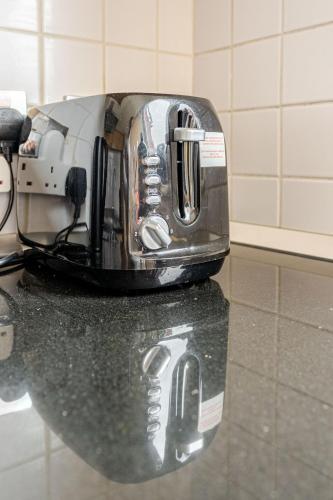 a toaster sitting on a counter in a kitchen at Amazing River view 2 bedroom apartment, sleeps 6 , balcony and parking in London
