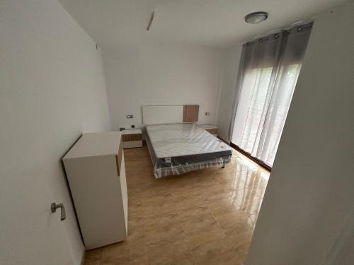 a small room with a bed and a window at Chalet in Salou