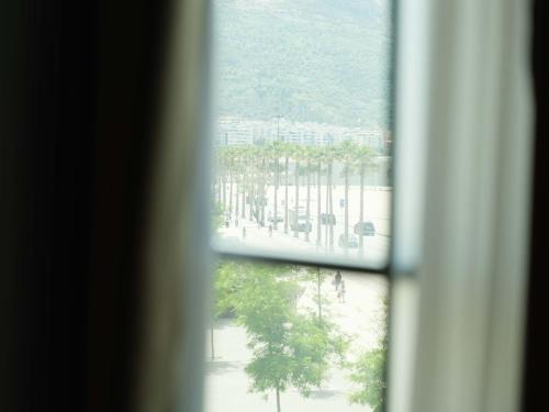 a view from a window looking out at a park at The Central View Boutique Hotel in Vlorë