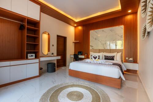 a bedroom with a large bed and a rug at 3BR Brand New Cozy Private Villa D'Pondok Balangan in Uluwatu