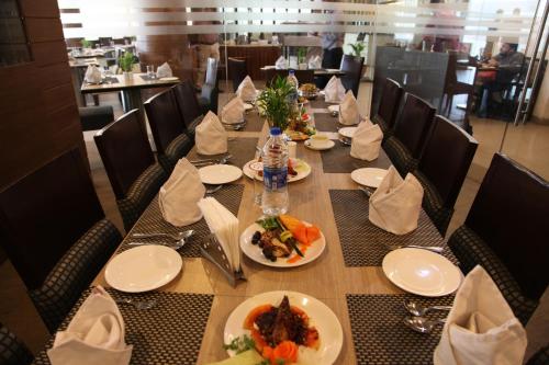 a table with plates of food on it in a restaurant at IRA By Orchid Bhubaneswar in Bhubaneshwar
