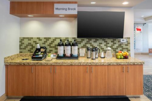 a kitchen with bottles of wine on a counter at TownePlace Suites by Marriott Billings in Billings