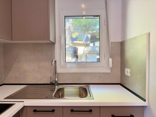 a kitchen with a sink and a window at Vlora forest Apartments in Vlorë