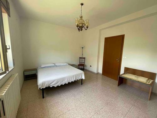 a bedroom with a bed and a chandelier at Wanderlust per chi ama la natura in Laino Castello