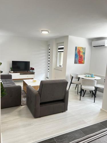 a living room with a couch and a table at Apartman Sara in Teslić