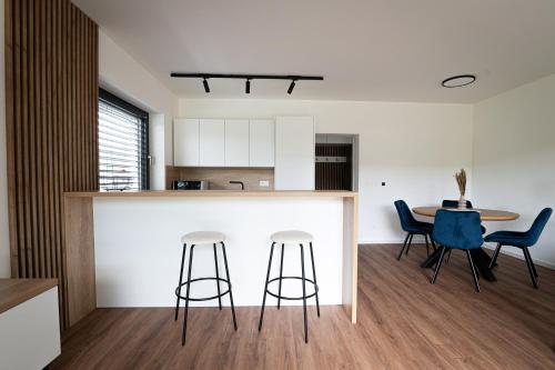 cocina y comedor con encimera y taburetes en Sunset Villa Mara, en Liptovský Trnovec