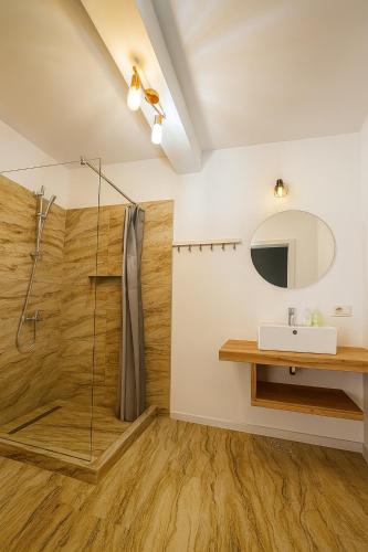 a bathroom with a shower and a sink and a mirror at Casa Maxim Eforie Nord in Eforie Nord