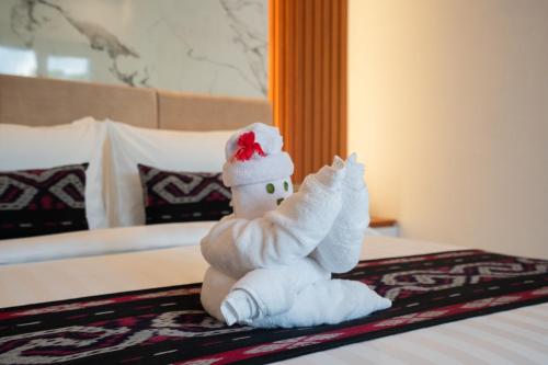 a stuffed snow man sitting on a bed at 3BR Brand New Cozy Private Villa D'Pondok Balangan in Uluwatu