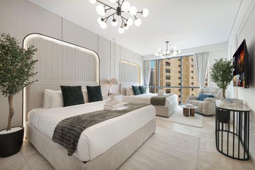 a bedroom with a large bed and a living room at JBR Coastal Escape - Amazing Sea Views, Pool & State-of-the-Art Gym in Dubai