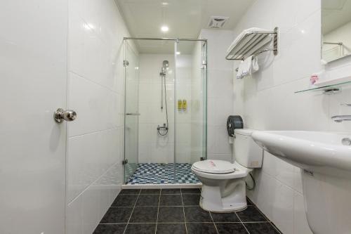 a bathroom with a shower and a toilet and a sink at The Cloud Hotel Zhongli Branch in Zhongli