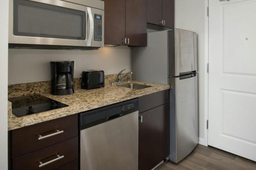 a kitchen with a sink and a microwave at TownePlace Suites by Marriott Billings in Billings