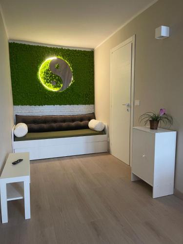 a living room with a green wall with a bench at Le Casette by Freshome in Turin