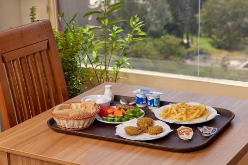 a tray of food on a table with food at Golden pyramids group in Nazlet el-Sîsi