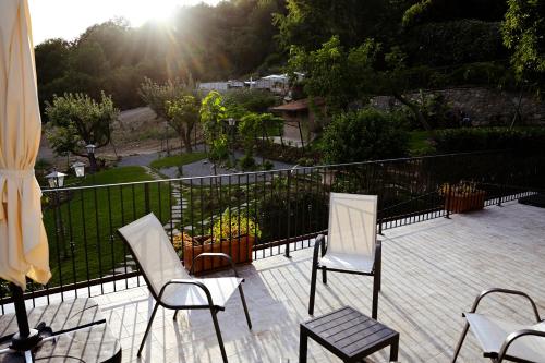 a balcony with three chairs and a fence at Old Village Linda - Tra Lunigiana & Cinque Terre in Comano