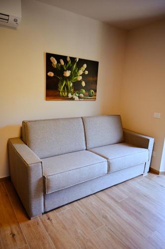 a couch in a room with a painting on the wall at Old Village Linda - Tra Lunigiana & Cinque Terre in Comano