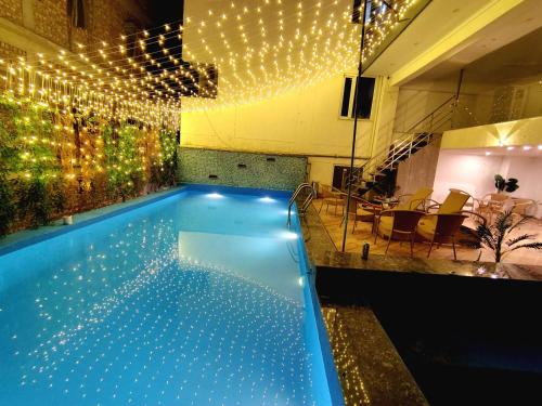 a swimming pool with christmas lights in a building at Hotel Tapovan Hills in Rishīkesh