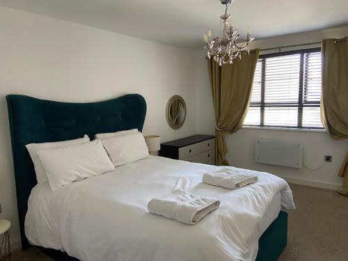 a bedroom with a large white bed with two towels on it at Marina Suite 1 Bed Duplex ER104 in Hull