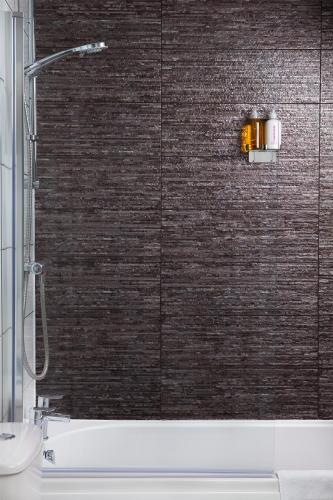 a shower in a bathroom with a brick wall at Marina Suite 1 Bed Duplex ER104 in Hull