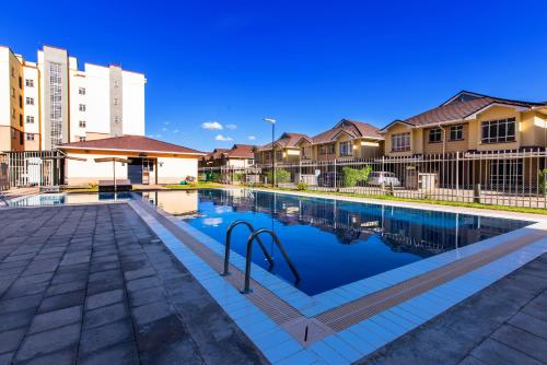 a swimming pool in front of some houses at JKIA SGR Crystal Rivers 3BR with Pool and Mall in Nairobi