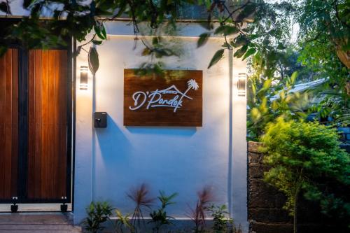 a sign on the side of a white building at 3BR Brand New Cozy Private Villa D'Pondok Balangan in Uluwatu