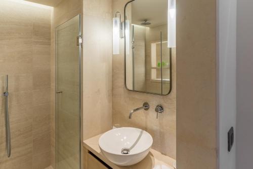 a bathroom with a sink and a shower at Rodos Park in Rhodes Town