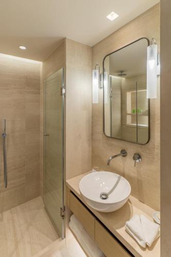 a bathroom with a sink and a shower at Rodos Park in Rhodes Town