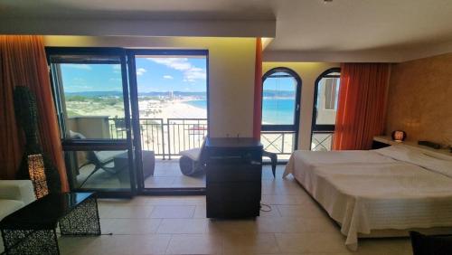 a bedroom with a bed and a view of the ocean at Beachfront Apartment Oasis VIP Club in Sunny Beach