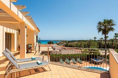 a house with a balcony with a view of the ocean at Villa Caballero by Villa Plus in Punta Prima