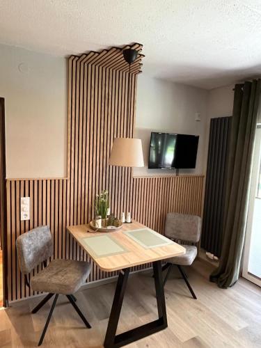 a dining room with a table and two chairs at FeWo Falk 26 OG am See in Arrach