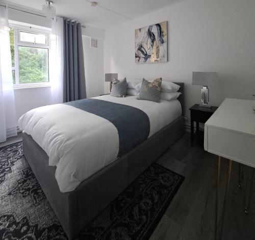 a bedroom with a large bed and a window at Three Bedroom Apartment in Brighton & Hove